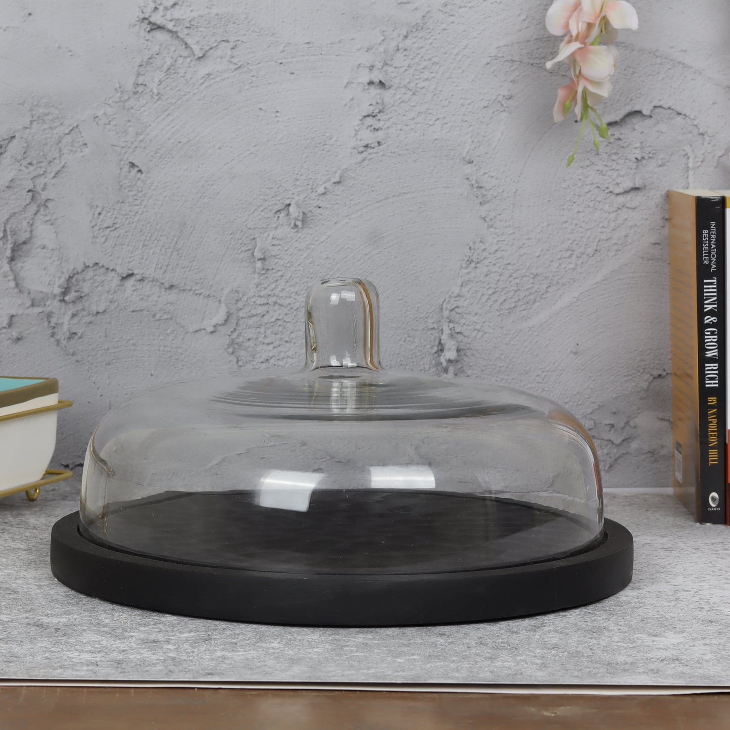 Glass-domed cake stand showcasing elegant dessert presentation for special occasions