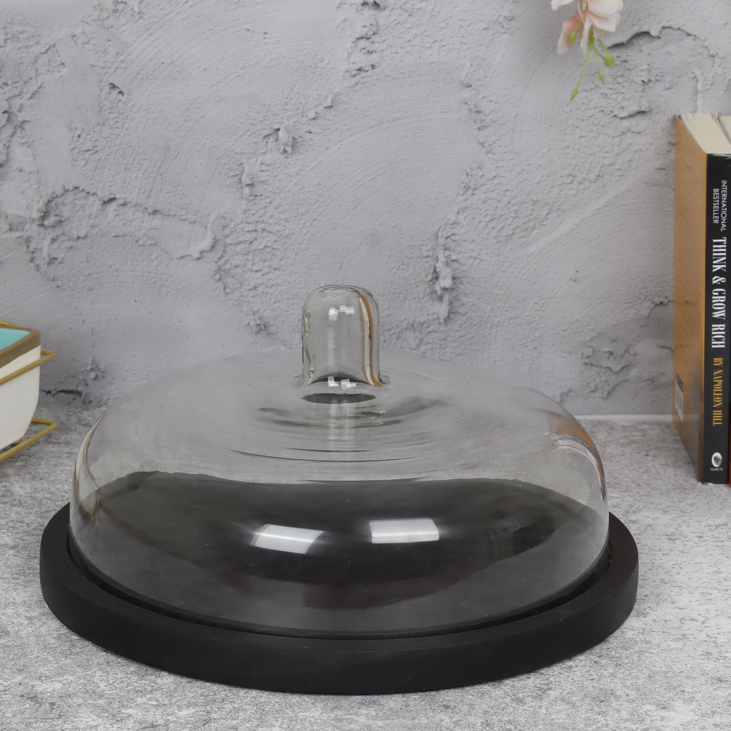 Glass-domed cake stand showcasing elegant dessert presentation for special occasions