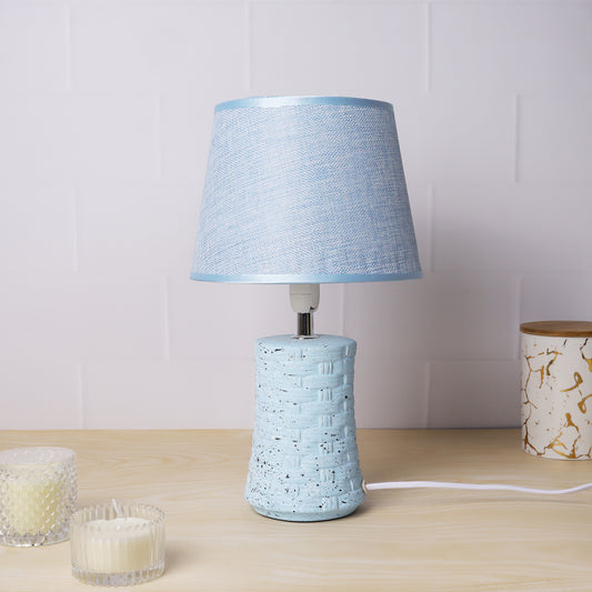 ceramic table lamp with textured base and linen shade, illuminating warmth and elegance