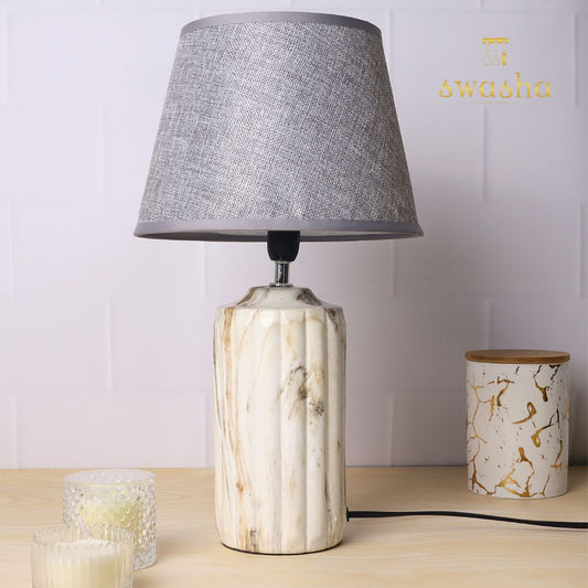 ceramic table lamp with textured base and linen shade, illuminating warmth and elegance