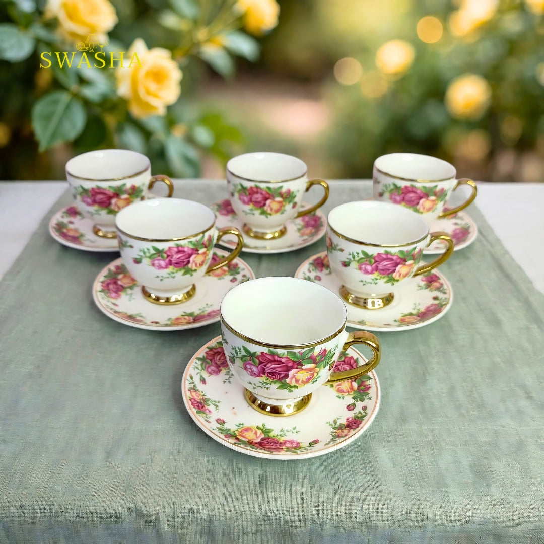 Swasha vintage floral cup saucer set of 6 english rose print with gold rim and gold foot on green table