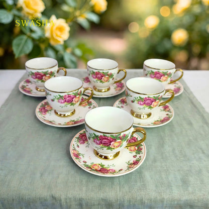 Swasha vintage floral cup saucer set of 6 english rose print with gold rim and gold foot on green table