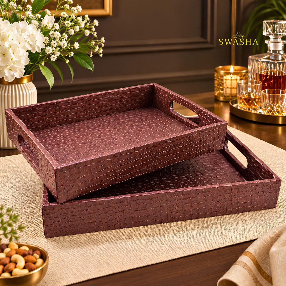Burgundy faux leather serving tray set of 2 with crocodile texture on coffee table with whiskey glasses and flowers