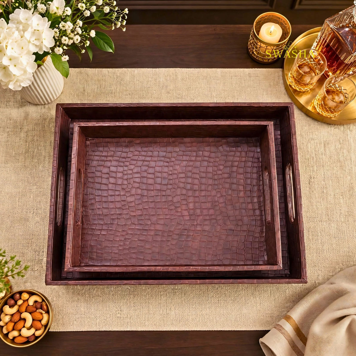 Burgundy faux leather serving tray set of 2 with crocodile texture on coffee table with whiskey glasses and flowers