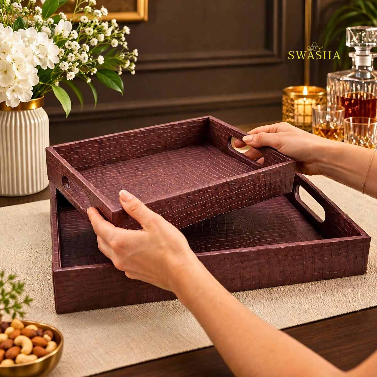 Burgundy faux leather serving tray set of 2 with crocodile texture on coffee table with whiskey glasses and flowers