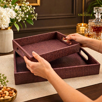 Burgundy faux leather serving tray set of 2 with crocodile texture on coffee table with whiskey glasses and flowers