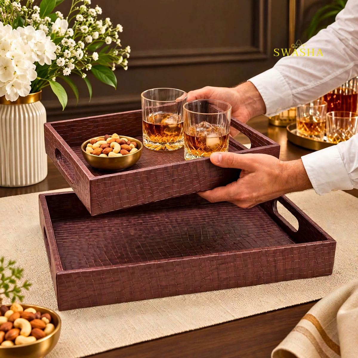 Burgundy faux leather serving tray set of 2 with crocodile texture on coffee table with whiskey glasses and flowers