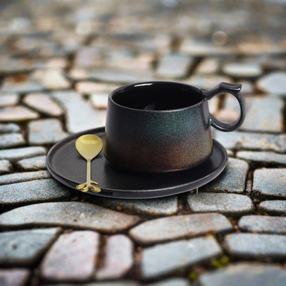 ceramic cup and saucer with spoon