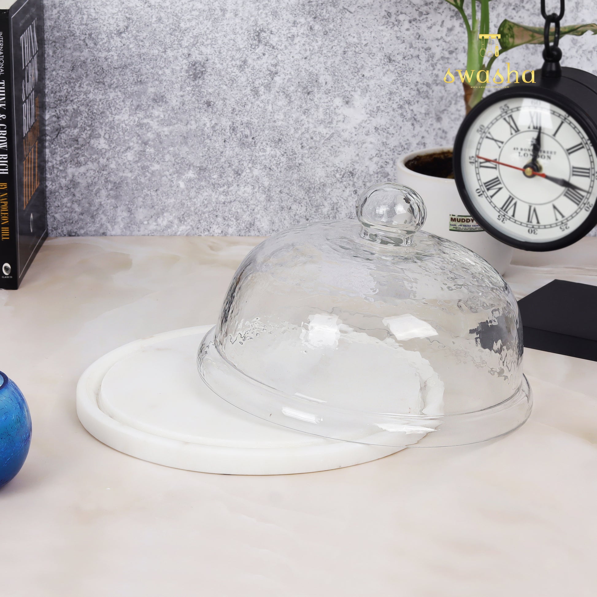 Glass-domed cake stand showcasing elegant dessert presentation for special occasions