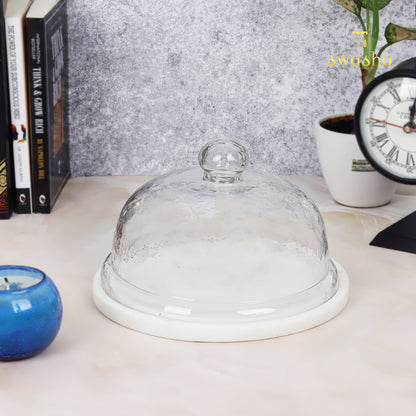 Glass-domed cake stand showcasing elegant dessert presentation for special occasions